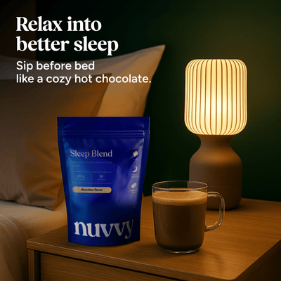 Nuvvy Sleep Blend pouch on a bedside table next to a warm drink and lamp.
